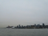 Carnival Majestic being escorted down the Hudson by a tug