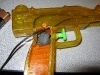 Trigger switch mounted behind trigger